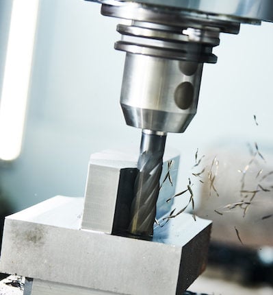 milling cnc machine at metal work industry. Multitool precision machining. Shallow depth of view on shavings